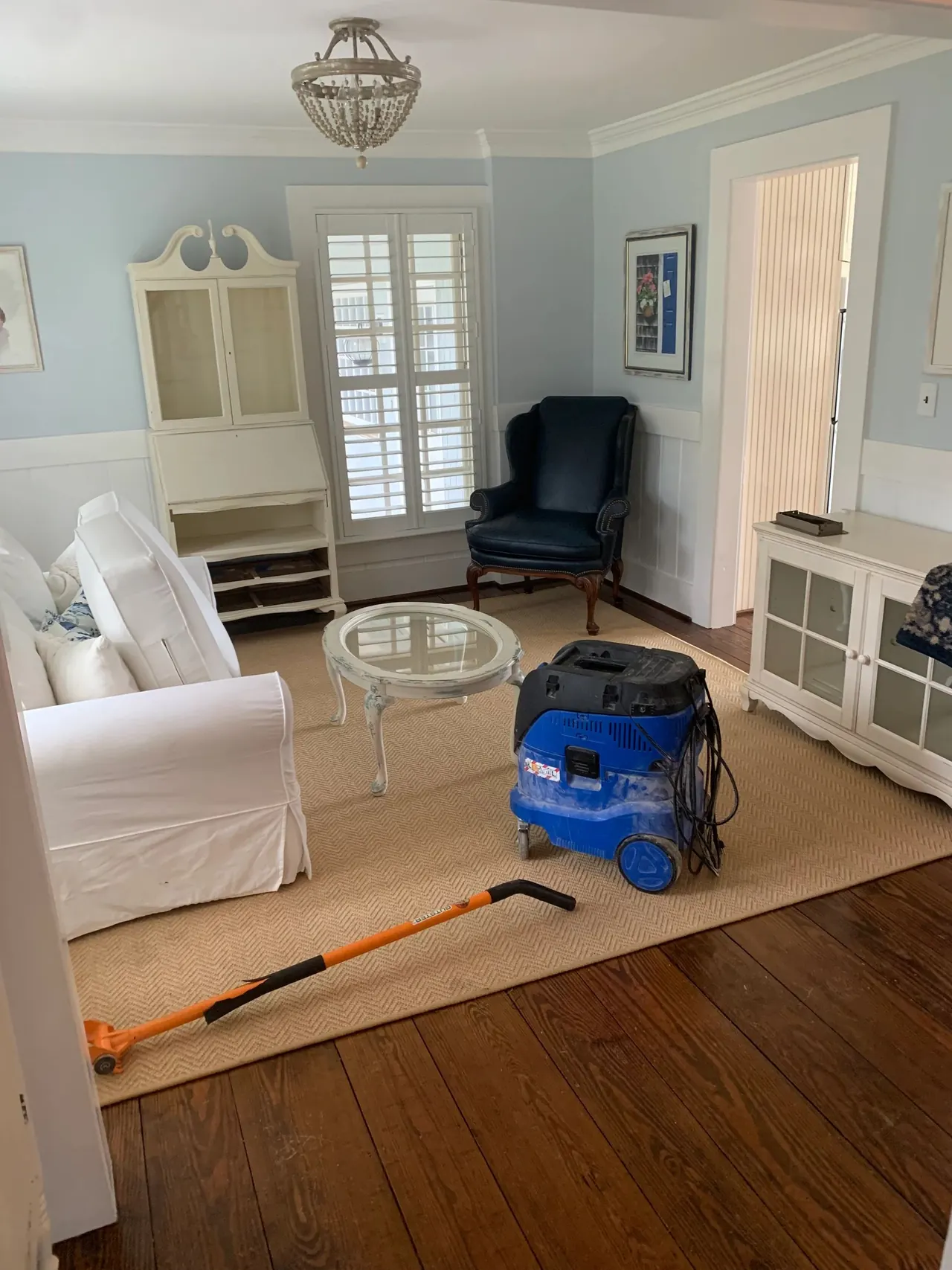 Pine floor refinishing in progress in a living room