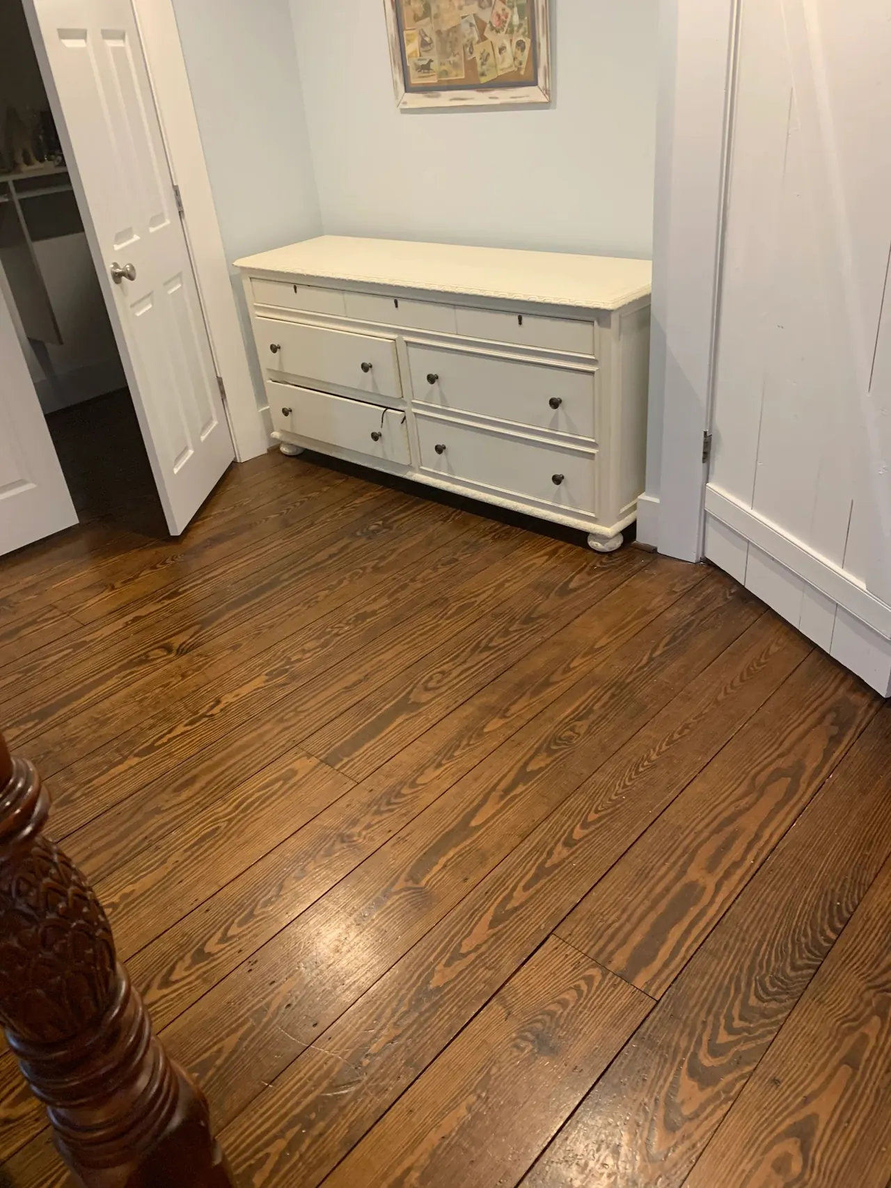 Refinished pine bedroom floor next to a white dresser