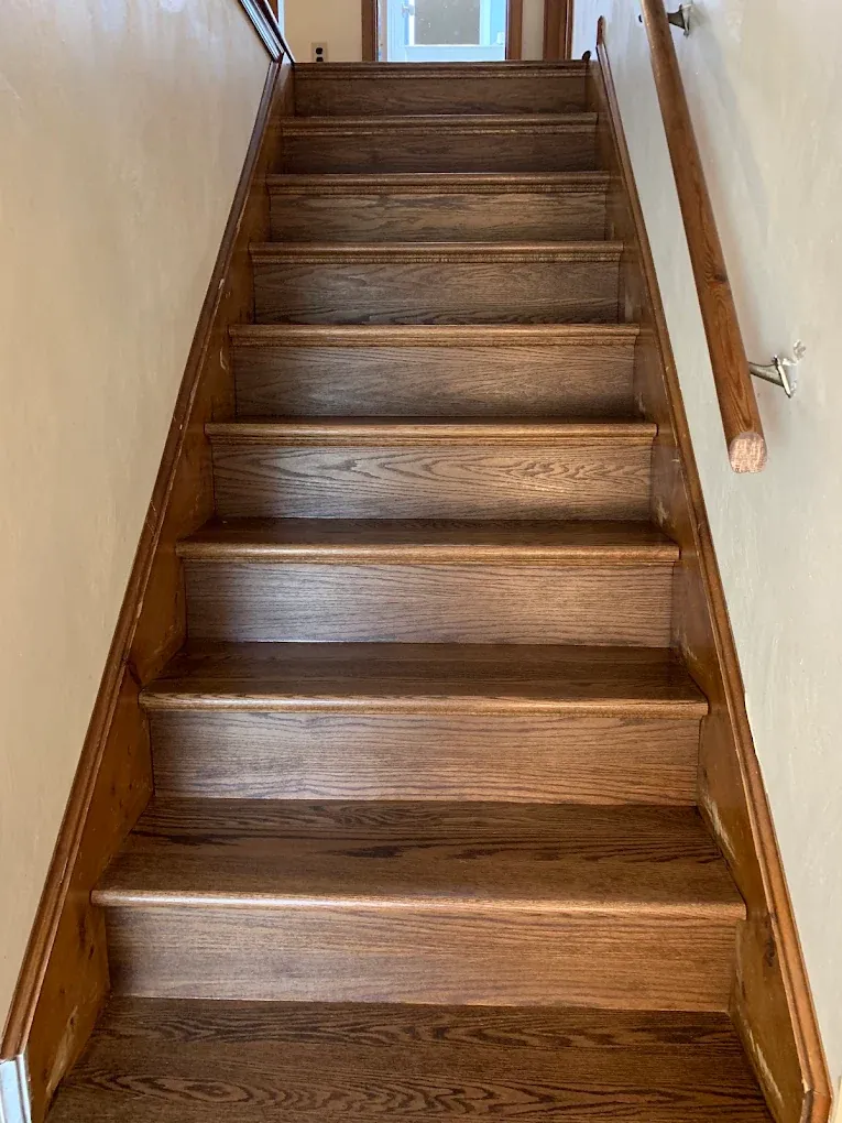 Stained oak stair treads and risers installed by ANR Flooring